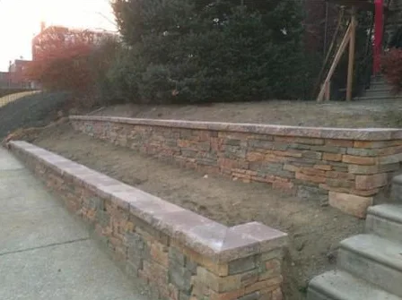 Segmental block retaining wall with capped steps