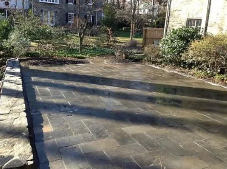Bluestone flagstone patio with a stone border in a backyard