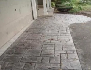 Gray stamped concrete walkway with an ashlar stone pattern